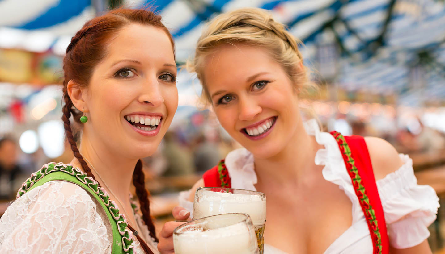 München - Women with traditional Bavarian clothes or dirndl in beer tent